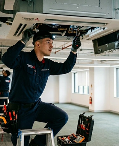 Technician fixing air conditioner